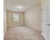 Bright, carpeted bedroom featuring a window with blinds allowing natural light at 8296 Portofino Dr # 103, Davenport, FL 33896