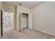 Bedroom has a closet with open doors, neutral carpet and window at 8296 Portofino Dr # 103, Davenport, FL 33896