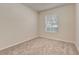 Carpeted bedroom featuring a large window and neutral colored walls at 8296 Portofino Dr # 103, Davenport, FL 33896