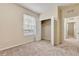 This room has a neutral carpet, window, and closet with opened double doors at 8296 Portofino Dr # 103, Davenport, FL 33896
