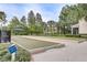 Community bocce ball courts with lush green landscape, mature trees, and a shaded seating area at 8296 Portofino Dr # 103, Davenport, FL 33896