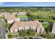 Aerial shot of condo building with tile roof overlooking a pond and parking lot at 8296 Portofino Dr # 103, Davenport, FL 33896