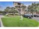 Exterior view of the community buildings, featuring lush landscaping, green grass and well-maintained grounds at 8296 Portofino Dr # 103, Davenport, FL 33896