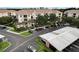 Condo building with tile roof and parking lot, with trees and landscaping at 8296 Portofino Dr # 103, Davenport, FL 33896