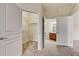 Walk-in closet with shelving and an open door to the adjacent bathroom at 8296 Portofino Dr # 103, Davenport, FL 33896