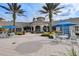 Elegant clubhouse entrance with covered seating, lush landscaping, and a welcoming atmosphere at 8296 Portofino Dr # 103, Davenport, FL 33896
