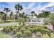 BellaTrae community sign surrounded by lush landscaping, mature trees, and vibrant greenery at 8296 Portofino Dr # 103, Davenport, FL 33896