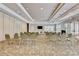 A well lit conference room offers chairs and tables for meetings or group events at 8296 Portofino Dr # 103, Davenport, FL 33896