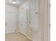 Neutral entryway featuring ceramic tile, closet space and white doors at 8296 Portofino Dr # 103, Davenport, FL 33896