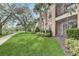 Apartment building with balconies, landscaping and a manicured lawn with walking path at 8296 Portofino Dr # 103, Davenport, FL 33896
