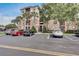 Beautiful three-story condo building showcasing ample parking and lush landscaping at 8296 Portofino Dr # 103, Davenport, FL 33896