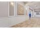 Elegant hallway featuring decorative wall panels, sconce lighting, and tiled flooring at 8296 Portofino Dr # 103, Davenport, FL 33896