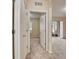 Hallway features neutral carpet, white trim, and leads to bedroom and living area at 8296 Portofino Dr # 103, Davenport, FL 33896