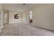 Living room with neutral carpet, white trim, and archways to other rooms at 8296 Portofino Dr # 103, Davenport, FL 33896