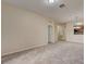 Spacious living room has neutral carpet, white trim and leads to kitchen at 8296 Portofino Dr # 103, Davenport, FL 33896