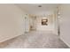 The living room offers neutral walls, carpeting and archways to the kitchen and hallway at 8296 Portofino Dr # 103, Davenport, FL 33896