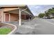 View of the covered parking area near the building with reserved parking spaces and a well-maintained exterior at 8296 Portofino Dr # 103, Davenport, FL 33896