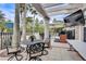Inviting patio with a large TV, elegant seating, and a pergola offering a relaxing outdoor experience at 8296 Portofino Dr # 103, Davenport, FL 33896