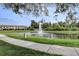 Beautiful pond with fountain, lush trees and lawn at 8296 Portofino Dr # 103, Davenport, FL 33896