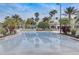 Inviting swimming pool surrounded by swaying palm trees, lush landscaping, and lounge chairs for ultimate relaxation at 8296 Portofino Dr # 103, Davenport, FL 33896