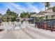 Expansive pool deck with rocking chairs and bar-style seating, perfect for community gatherings and relaxation at 8296 Portofino Dr # 103, Davenport, FL 33896
