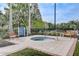 Relaxing community spa area featuring a hot tub, benches, and lush landscaping for a serene retreat at 8296 Portofino Dr # 103, Davenport, FL 33896