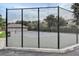 View of the fenced community tennis court with new net and well-maintained playing surface at 8296 Portofino Dr # 103, Davenport, FL 33896