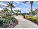 Beautifully landscaped walkway leading to the pool with lush plants, palm trees and seating areas at 8296 Portofino Dr # 103, Davenport, FL 33896