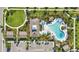 Aerial view of community pool surrounded by lounge chairs, green space, and tropical landscaping at 8972 Sonoma Coast Dr, Winter Garden, FL 34787
