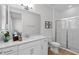 Bright bathroom featuring a glass enclosed shower, a single sink vanity and modern fixtures at 8972 Sonoma Coast Dr, Winter Garden, FL 34787
