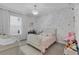 A whimsical bedroom with polka dot wallpaper, plush toys, and plenty of natural light at 8972 Sonoma Coast Dr, Winter Garden, FL 34787