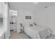 Charming bedroom with a view to an ensuite bathroom, featuring neutral tones and stylish decor at 8972 Sonoma Coast Dr, Winter Garden, FL 34787