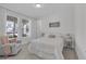 Bright bedroom with neutral decor, a comfortable chair, and view of the outdoors at 8972 Sonoma Coast Dr, Winter Garden, FL 34787