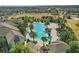 Aerial view of the resort-style community pool, surrounded by palm trees and lush landscaping at 8972 Sonoma Coast Dr, Winter Garden, FL 34787
