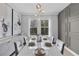 Elegant dining room with modern decor, stylish lighting, and a large window view at 8972 Sonoma Coast Dr, Winter Garden, FL 34787
