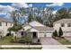 An elevated view showcases the home's appealing facade, complemented by lush landscaping and a brick-paved driveway at 8972 Sonoma Coast Dr, Winter Garden, FL 34787