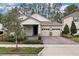 Charming single-story home with a brick driveway and a well-manicured front yard, showcasing its inviting curb appeal at 8972 Sonoma Coast Dr, Winter Garden, FL 34787