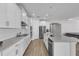 Spacious kitchen with a central island, stainless steel appliances, and wood-look tile flooring at 8972 Sonoma Coast Dr, Winter Garden, FL 34787