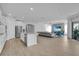 Expansive living area showcasing a kitchen island with modern appliances, a comfortable sofa, and dining area at 8972 Sonoma Coast Dr, Winter Garden, FL 34787