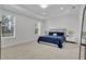 Comfortable main bedroom with carpet flooring, two windows, and bedside tables at 8972 Sonoma Coast Dr, Winter Garden, FL 34787