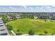 Expansive green field in the community, surrounded by homes, playground and community pool at 8972 Sonoma Coast Dr, Winter Garden, FL 34787