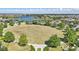 Vast green space near the lake, surrounded by trees and benches, perfect for community activities at 8972 Sonoma Coast Dr, Winter Garden, FL 34787