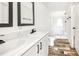 Clean bathroom features double sink vanity, framed mirrors, and a walk-in shower, providing modern convenience at 9055 Atlas Dr, St Cloud, FL 34773