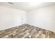 Simple bedroom with modern flooring, white walls, single window, and standard door, offering a blank canvas at 9055 Atlas Dr, St Cloud, FL 34773