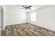 Bright, empty bedroom with modern flooring, white walls, and a ceiling fan, offering a versatile space at 9055 Atlas Dr, St Cloud, FL 34773