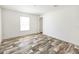 Bedroom features wood look flooring, base molding, and natural light at 9055 Atlas Dr, St Cloud, FL 34773