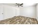 This bedroom features wood-look floors, white walls, and a ceiling fan at 9055 Atlas Dr, St Cloud, FL 34773