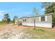 Beautiful home featuring a new wooden staircase leading to the front entrance with green horizontal siding at 9055 Atlas Dr, St Cloud, FL 34773