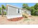 Charming home featuring a new wooden staircase leading to the front entrance and new landscaping at 9055 Atlas Dr, St Cloud, FL 34773