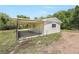 View of the garage featuring an attached carport with a concrete slab foundation at 9055 Atlas Dr, St Cloud, FL 34773